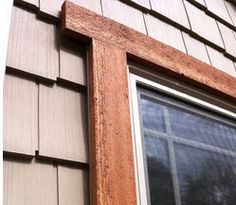 a cat sitting in the window of a house