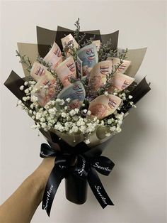 a bouquet of flowers is wrapped in black ribbon