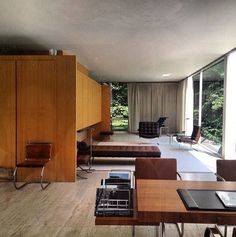 a living room filled with furniture and large windows