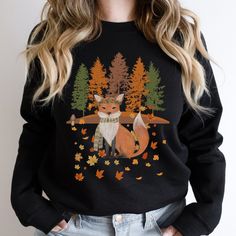 Cute fox tree leaves sweatshirt is a great addition to any nature lovers and fox lover's wardrobe this season. Beautiful fall scene and fox makes this sweat shirt truly adorable to wear on any occasion. This vintage cottagecore sweater makes a great gift for mom, gift for grandma, gift for a friend, gift for a daughter, gift for nature lover, gift for fox lovers, fall gifts.  OUR ADULT SWEATSHIRTS Our designs are printed on a heavy blend crewneck unisex sweatshirt made out of a combination of 50 Cozy Fall Sweatshirt Gift, Cozy Sweatshirt For Fall Gift, Cozy Sweatshirt For Fall, Long Sleeve Sweatshirt For Fall Gift, Cozy Fall Sweater Gift, Cozy Sweater For Fall Gift, Crew Neck Sweater For Fall - Great As Gift, Cotton Sweater As Fall Gift, Cotton Sweater For Fall, Perfect As A Gift