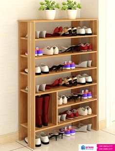 a shelf filled with lots of shoes next to a potted plant