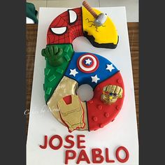 a birthday cake made to look like the avengerss and captain america symbols are on display