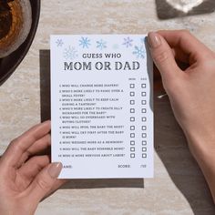 a person holding up a card with the words guess who mom or dad on it