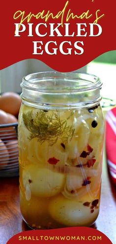 a jar filled with pickled eggs sitting on top of a wooden table