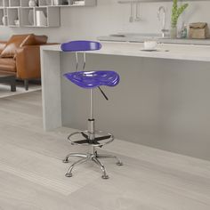 a blue stool sitting on top of a wooden floor next to a kitchen countertop