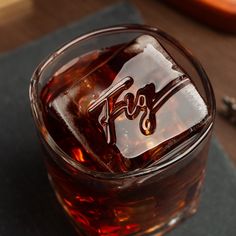 a close up of a drink in a glass on a table