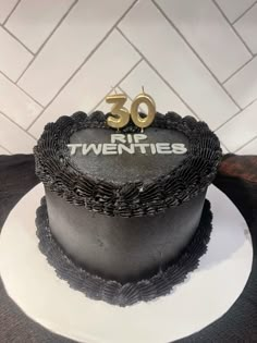 a black and white cake with the number 50 on it