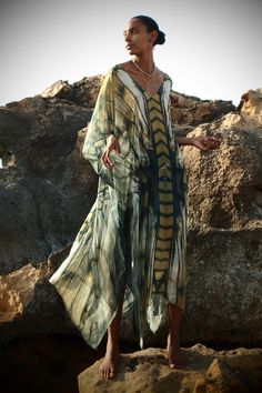 Freya Ashtanga Kaftan, this beautiful v-neck printed caftan in pure silk is cut oversized for an elegant drape and voluminous movement. Featuring a deep v-neckline and adjustable tie at the back. This dress can be transformed from day to night. Wear it as evening wear or as part of your beach outfit. 100% Silk Dry clean Handmade in Ireland FREYA PRINT: A dragonfly inspired print with shiny, iridescent, delicate and intricate wings in an ombre palette of metallics, antique gold, copper, bronze, c