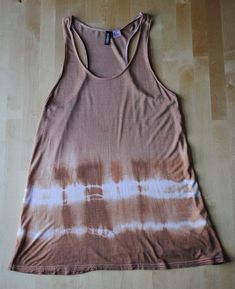 a women's tank top that has been dyed with brown and white dye on it