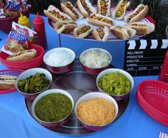 there are many hot dogs and other foods on the table