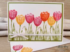 a card with watercolor tulips on it