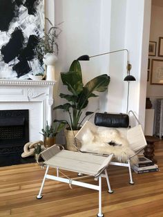 a living room filled with furniture and a fire place next to a painting on the wall