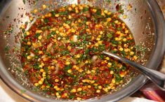 a large metal bowl filled with food on top of a table