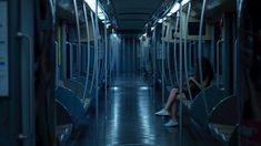 a woman is sitting on the subway train