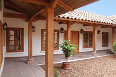 an outside view of a house with potted plants