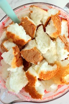 a bowl filled with bread and cream on top of a table