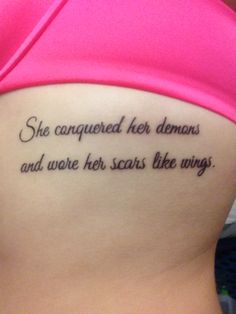 a woman with a tattoo on her stomach that says she conquer her demons and wore her scars like wings