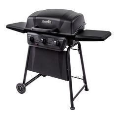 a black bbq grill with wheels on it's side and the lid open