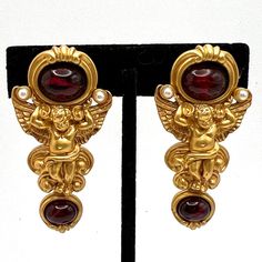 Elizabeth Taylor For Avon Gilded Age Cherub Clip Earrings 1994 Gilded Age Collection Gold Cherubs Bear Impressive Cabochons Simulating The Look Of Artfully Flawed Rubies Comfort Pad On Clip No Original Boxes Gently Worn Excellent Vintage Condition Gilded Age, Avon Jewelry, Elizabeth Taylor, Clip Earrings, Earrings Color, Red Gold, Clip On Earrings, Original Box, Jewelry Earrings