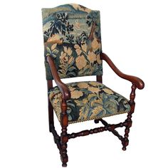 an upholstered arm chair with floral fabric