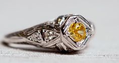 * VIEW A VIDEO OF THIS RING: https://youtu.be/51Y8HNsQSYQ * Extremely rare GIA CERTIFIED fancy intense orangy yellow diamond. The center stone is .20ct and is beaitufully surrounded by .07ct diamonds all near the upper shank. Hand crafted designed runs to the middle of the ring with custom breaks on the top and bottom of this unbelievable ring. It is very rare that we see such a color on a diamond. Fancy Intense is one of the most desirable color hue's in the world, and adding a the Orange tone Yellow Diamond Cut Platinum Ring, Yellow Platinum Diamond Ring With Diamond Cut, Yellow Platinum Diamond Wedding Ring, Yellow Platinum Diamond Ring Fine Jewelry, Yellow Platinum Diamond Ring, Fine Jewelry Yellow Diamond Platinum Ring, Luxury Yellow Diamond Hallmarked Ring, Luxury Yellow Diamond Ring Hallmarked, Yellow Platinum Wedding Rings