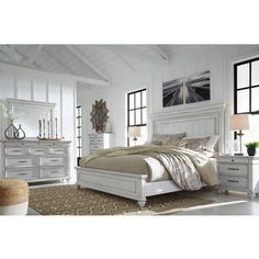 an image of a bedroom setting with white furniture