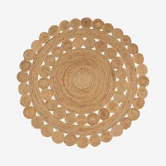 a round rug made out of straw with circles in the middle and bottom, on a white background