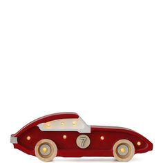 a wooden toy car with lights on it's sides and the number seven in the front