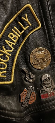 a leather jacket with several patches on it