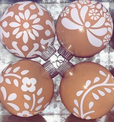 four brown and white ornaments sitting on top of each other