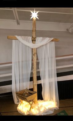 a cross made out of wood with lights on it