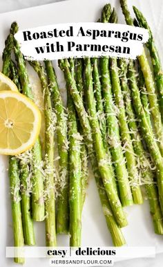 roasted asparagus with parmesan cheese and lemon on a white platter