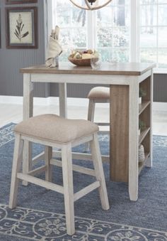 a dining room table with two stools and a bench in front of the window