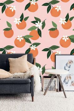 an orange wallpaper with white flowers and green leaves on it in a living room