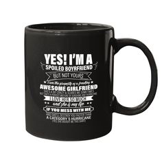 a black coffee mug with the words yes i'm a spoiled boyfriend but not yours