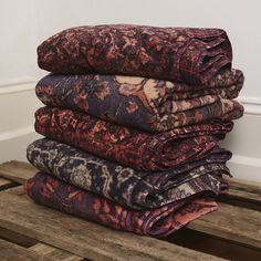 a stack of blankets sitting on top of a wooden pallet