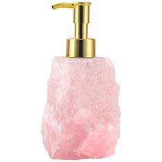 a pink soap dispenser with a gold faucet sitting on top of it