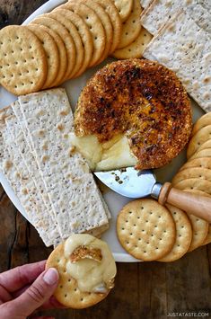 a plate with crackers, cheese and crackers on it