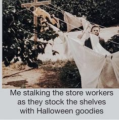 an image of clothes hanging on a line with the caption, me stalking the store workers as they stock the shelves with halloween goods