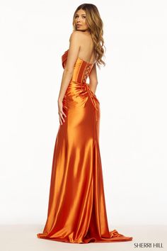 Sherri Hill style 55931 is a sleek stretch satin Sherri Hill prom dress with strapless sweetheart neckline, corset bodice, and flattering knot detail at the waist. The straight skirt is complete with a slit, while the back of the gown features a flattering ruching on the bum and a lace-up bodice that will keep your waist snatched for the Gods! Finally, ruching at the bustline is the final fabulous detail. You're going to look effortlessly fabulous in this long Sherri Hill prom or evening dress. Corset Prom Dress, Sherri Hill Prom, Silk Satin Dress, Sherri Hill Prom Dresses, Corset Dress Prom, Strapless Sweetheart Neckline, Strapless Corset, Corset Bodice, Sherri Hill Dresses