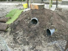 there are two pipe holes in the ground that look like they have been dug up