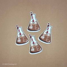 four brown and white lab flasks with red striped straws stickers on them