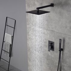 an open shower head and hand held shower faucet in a bathroom with grey walls