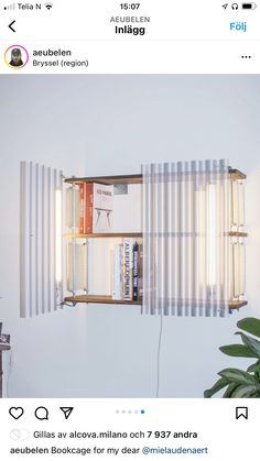 an image of a room with bookshelves on the wall and lights in the window