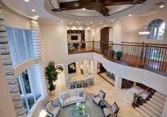 a living room filled with furniture and a spiral staircase