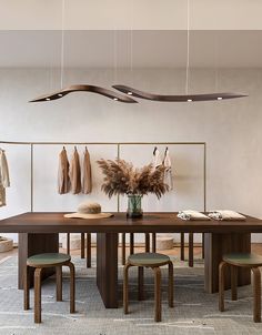 a dining room table with chairs and hanging lights