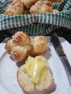 a white plate topped with rolls covered in butter