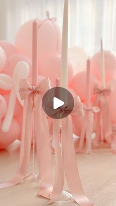 pink balloons and candles are arranged on the floor