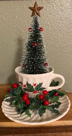 a christmas tree sitting in a cup on top of a plate