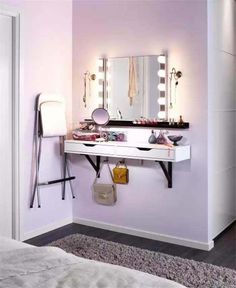 a white vanity with lights on it in a room